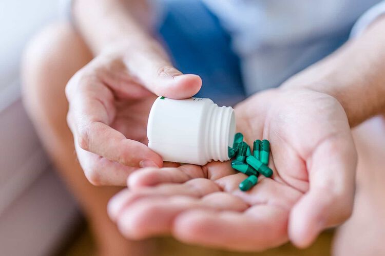 allergy pills in hand