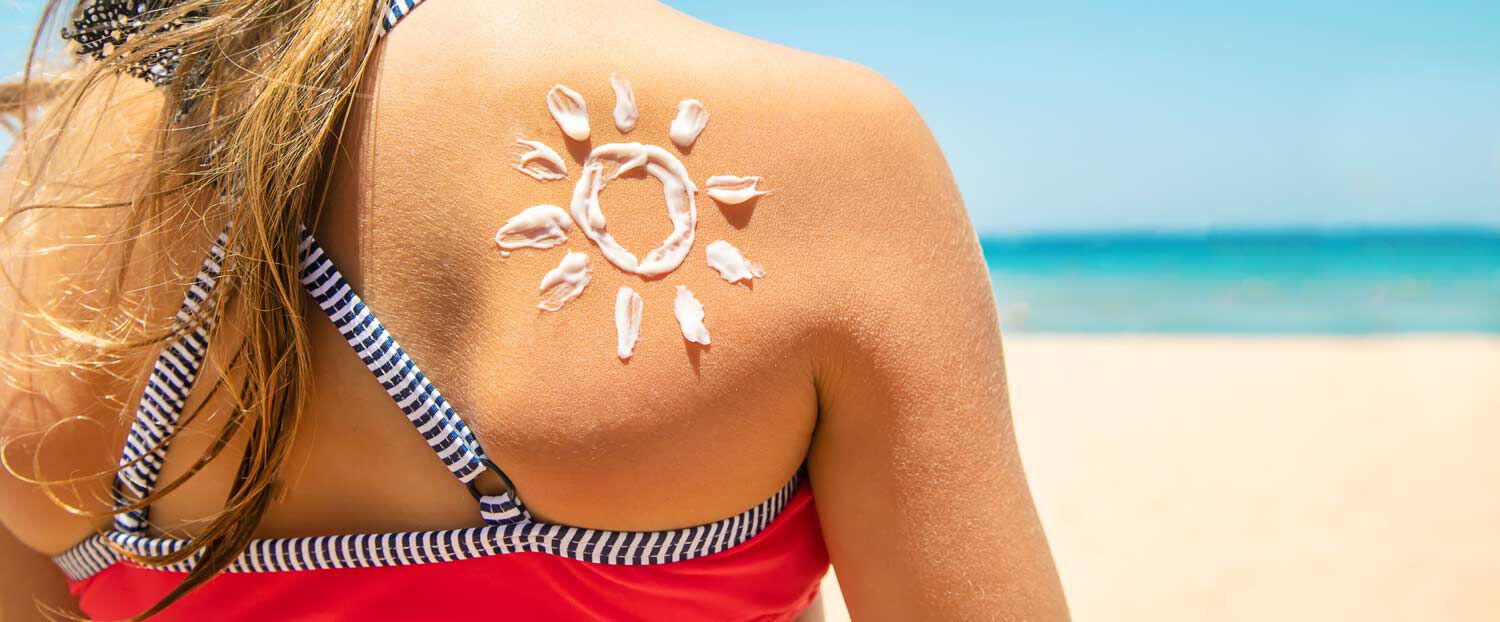 Woman on a beach with sunscreen applied on her skin